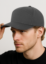 Man wearing a gray cap against a plain background